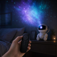 Hand adjusting brightness and rotation speed with the Nebulux remote, projector glowing softly in the background